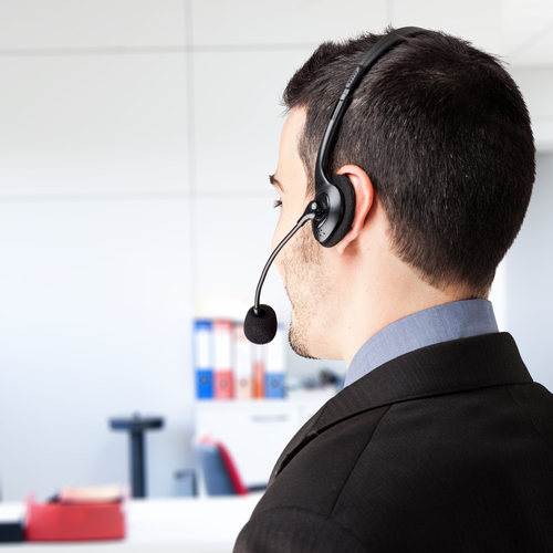 Image of man wearing telephone headset