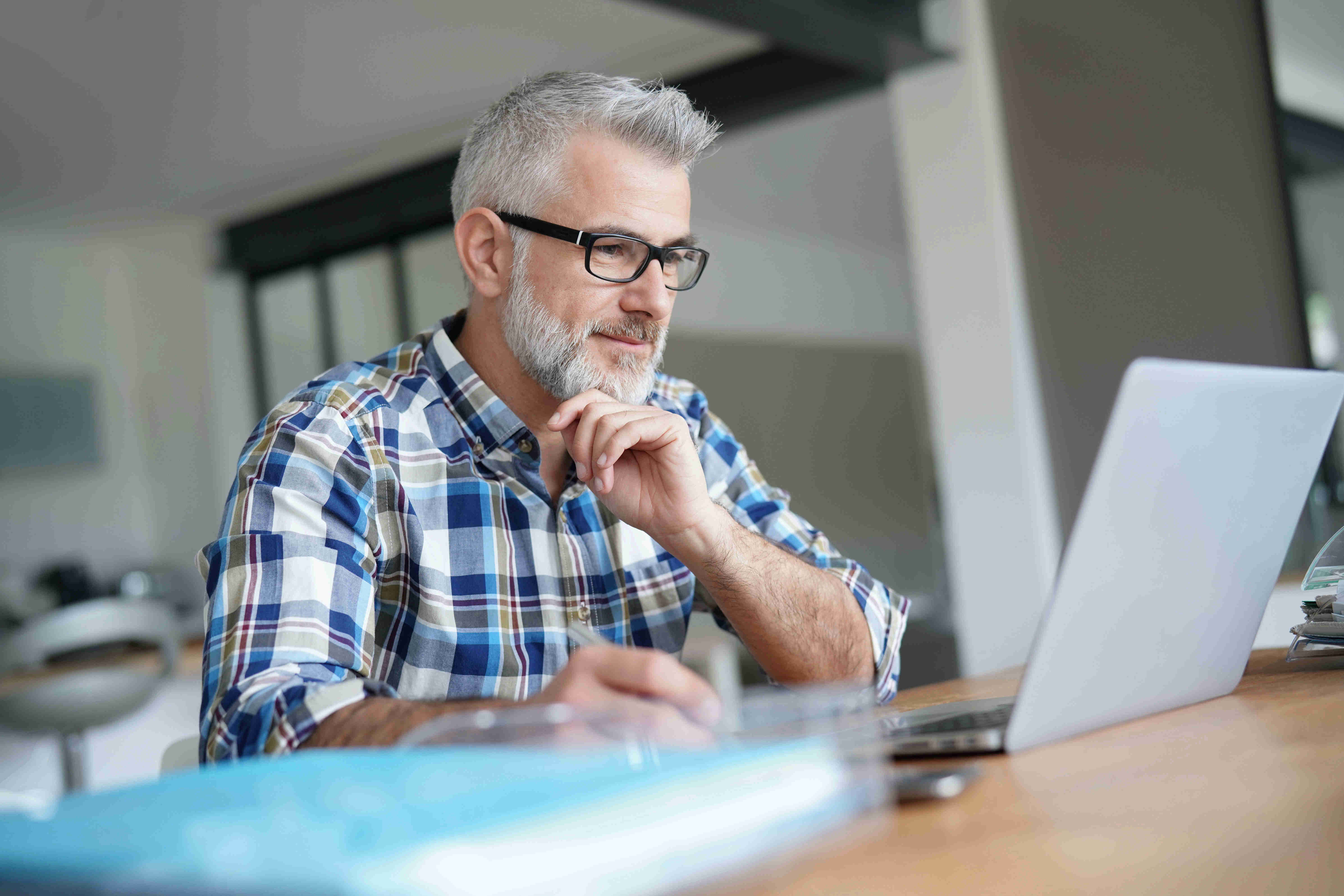 Male working on a laptop from home