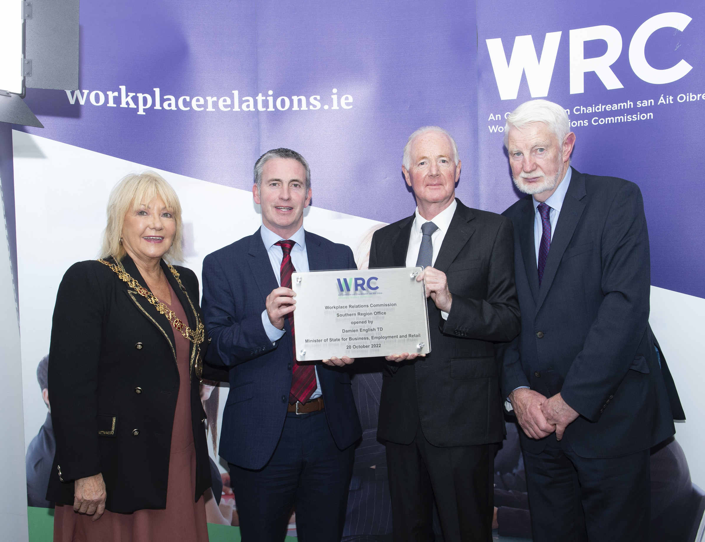 An image of 4 persons holding the plaque to commemorate the opening of the WRC Cork office