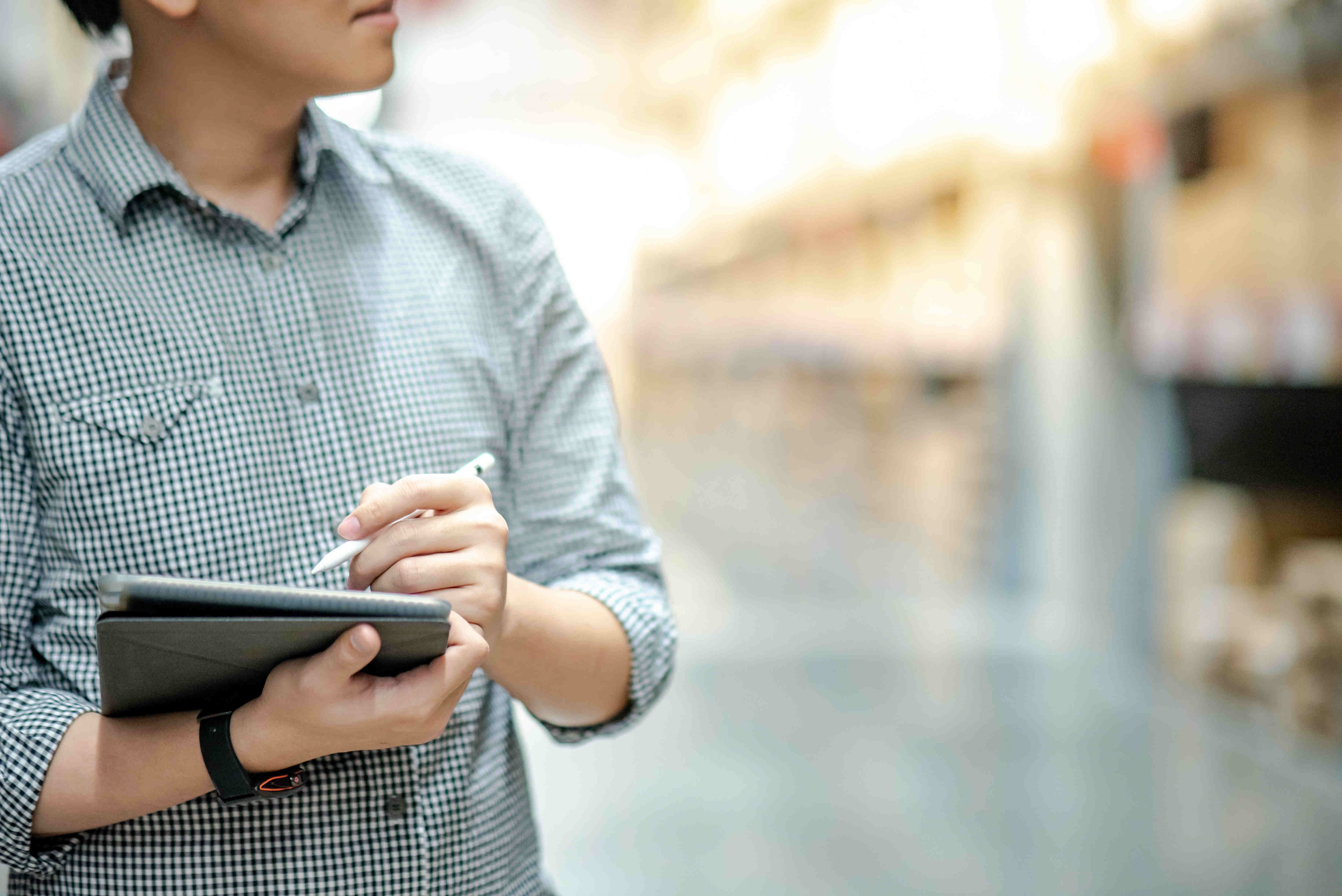 An image of an inspector holding a tablet device