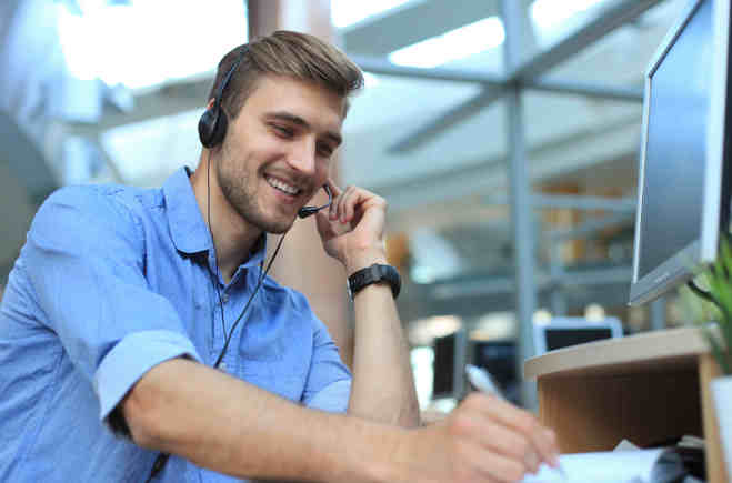 AdobeStock_208568684 A man answering phone calls in a call centre