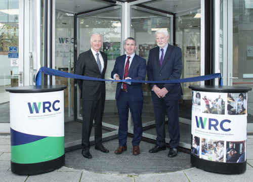 WRC240 3 males cutting a ribbon to open the WRC Cork office
