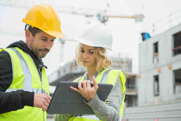 Constuction---2-people Image of a male and a female construction worker looking at a clipboard